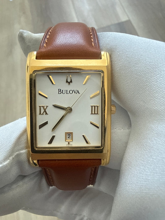 Bulova rectangular dress watch, gold-tone case on a leather strap, quartz movement