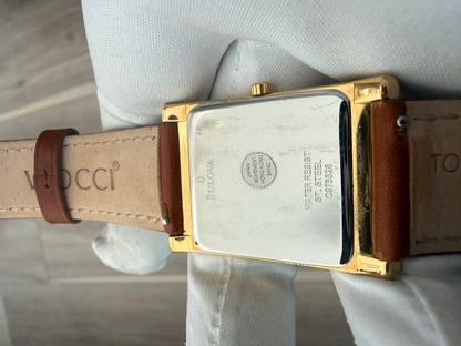 Bulova rectangular dress watch, gold-tone case on a leather strap, quartz movement