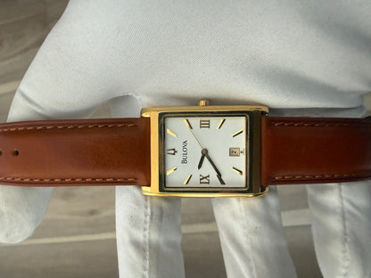 Bulova rectangular dress watch, gold-tone case on a leather strap, quartz movement